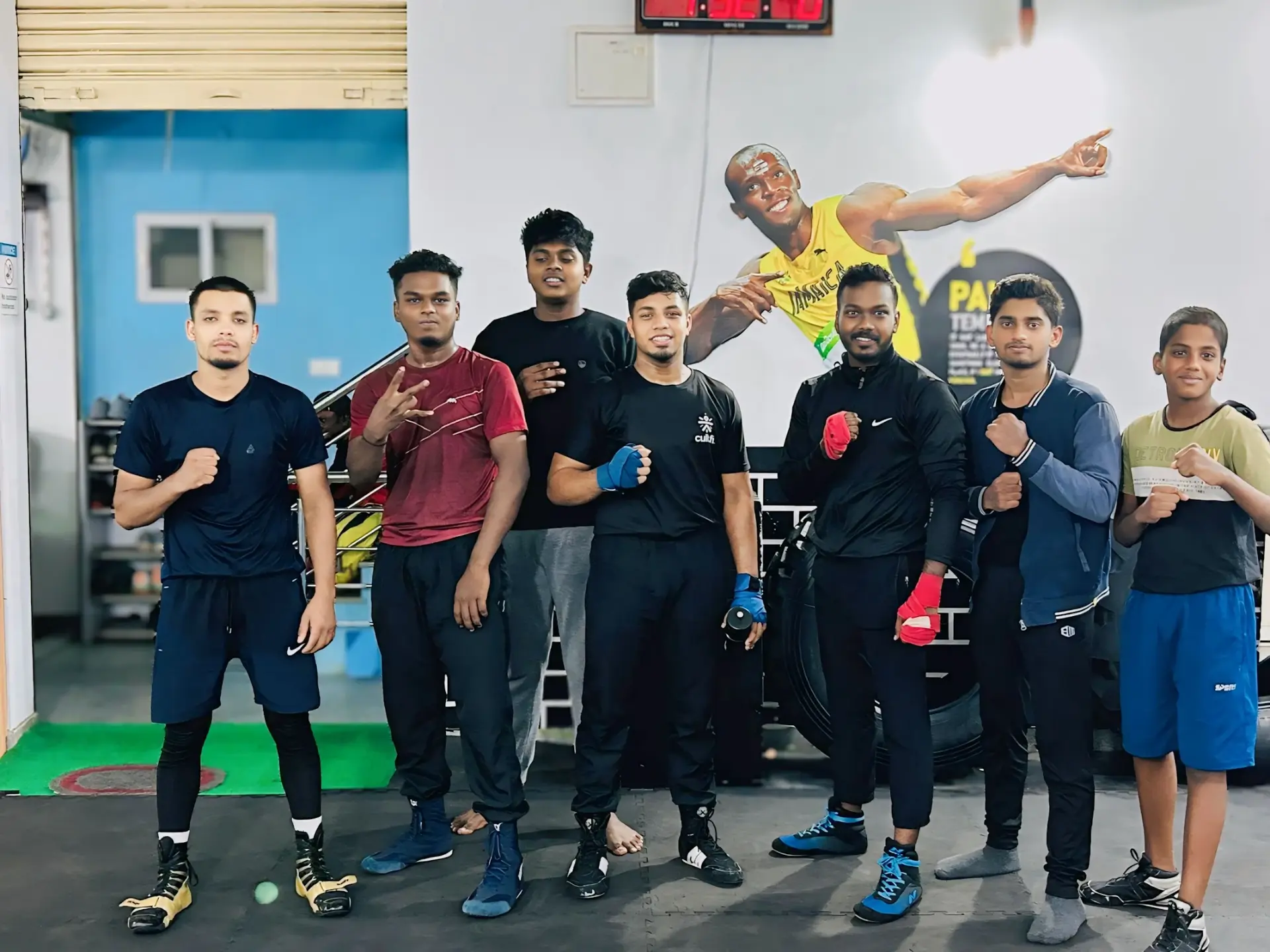 Boxing Warriors squad posing with hand wraps inside the gym