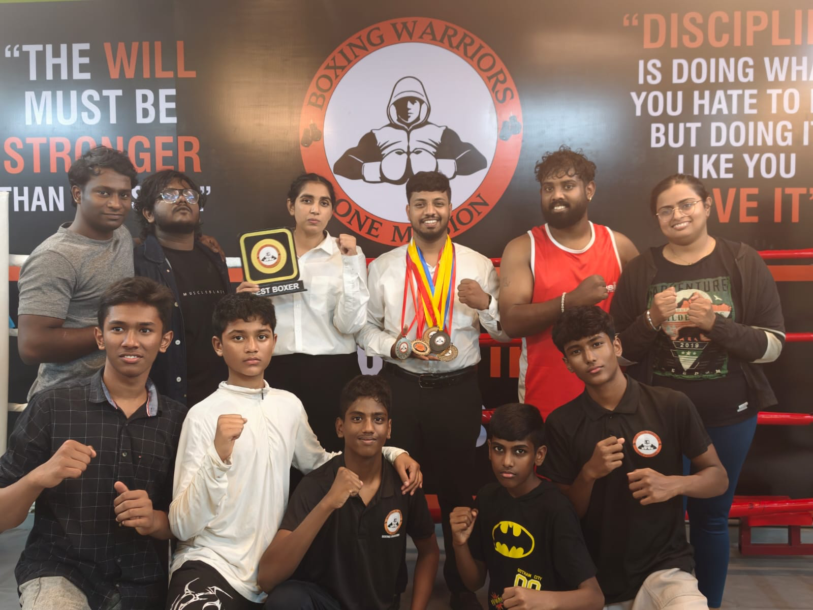 Boxing Warriors team with medals and trophies inside the ring