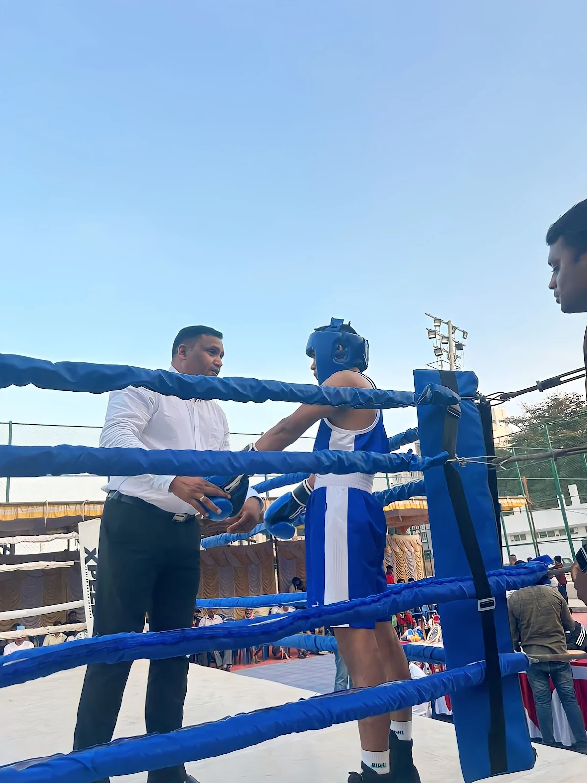 Coach preparing a Boxing Warriors athlete in the ring